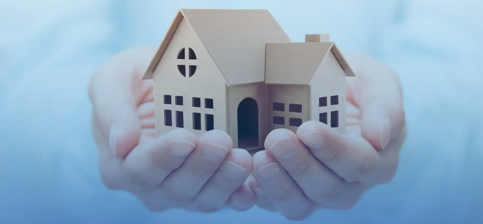 A property manager is holding dummy home in Chicago in her hands